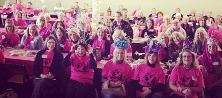The Pulpwood Queens in matching pink t-shirts and tiaras. There appear to be forty or fifty of them.